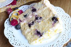 two slices of cake on plates with berries