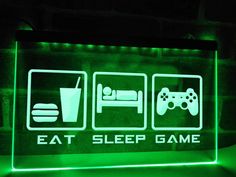 a neon sign that says eat sleep game with two video games on the front and side