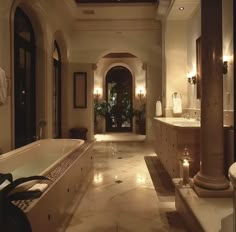 a large bathroom with two sinks and a bathtub in the middle of the room