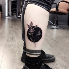 a person with a flower tattoo on their leg