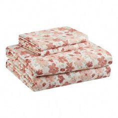 the pink floral sheet set is folded on top of each other