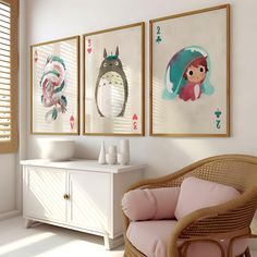 three framed pictures hang on the wall above a wicker chair in a white room