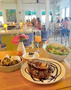 a wooden table topped with plates of food