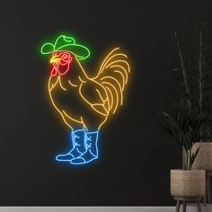 a neon sign with a rooster wearing a hat and boots