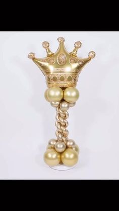 a gold and white vase with pearls on it