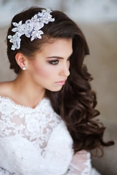 a woman with long hair wearing a white dress and a tiara on her head