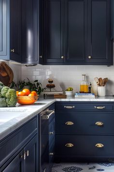 a kitchen with dark blue cabinets and white counter tops is seen in this image from the front view