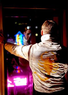 a man standing in front of a door with his arms out to the other side