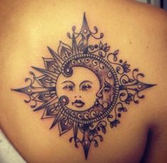 a woman's back with a sun and moon tattoo design on her left shoulder