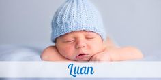 a baby wearing a blue knitted hat with the word leo written on it's side