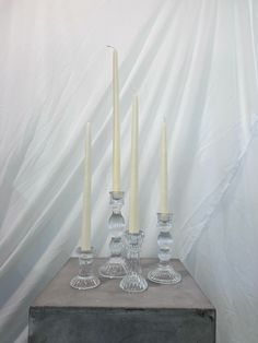 there are four candles that are on the table