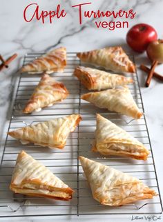 9 apple turnover triangles sit on a wire cooling rack which sits on a grey marble countertop. The turnovers have icing drizzled over the top and there's some whole apples and cinnamon sticks in the background. Dark red text at the top reads "apple turnovers vegan" Vegan Apple Turnovers, Barbecue Cauliflower, Apple Turnovers Recipe, Allergy Free Baking, Vegan Cauliflower Wings, Baked Cauliflower Bites, Apple Turnover Recipe, Phyllo Dough Recipes, Phyllo Recipes