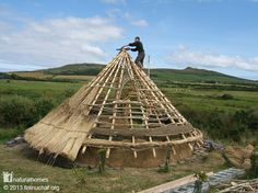 a man standing on top of a wooden structure