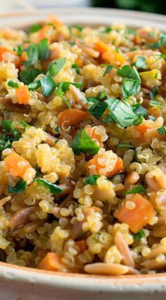 a bowl filled with rice and vegetables on top of a table