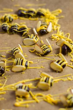 some yellow and black candy sticks are on the table with other food items around them