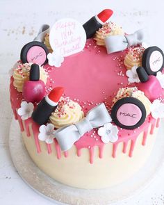 a birthday cake with pink icing and decorations