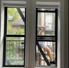 a woman is sitting on the window sill