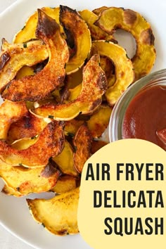 air fryer delicatia squash on a plate with ketchup and sauce