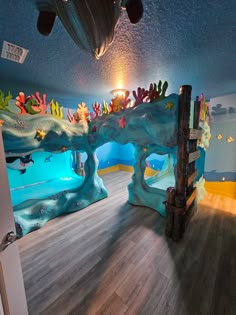 the room is decorated with fish and corals for children's playroom decor