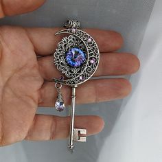 This handmade fantasy moon key necklace is magical, indeed!  With an artsy crescent moon and high quality Swarovski crystals, this piece of fantasy jewelry will truly make you sparkle.  It would also make an excellent gift for lovers of fairies and magical things! The magical key pendant measures a generous 3" tall and 1.5" wide and will come on a silver toned chain in the length of your choice.  If you are unsure what length you need, I can add 2" of additional chain to make it adjustable.  For Magical Jewelry Pendants, Fantasy Jewelry Magic, Blue Crystal Necklace, Fairy Jewelry, Magical Jewelry, Key Necklace, Key Pendant, Diy Crafts Jewelry, Fantasy Jewelry