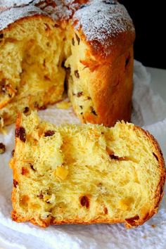 a loaf of bread with raisins and powdered sugar is cut in half