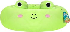 a green bean bag with two eyes and a smile on its face, sitting in front of a white background