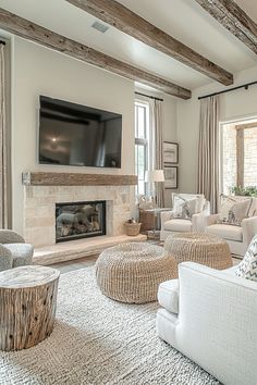 a living room filled with furniture and a flat screen tv mounted on the wall above a fire place