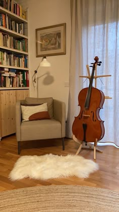 a living room filled with furniture and a musical instrument on top of a wooden floor