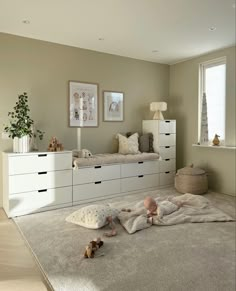 a bedroom with white furniture and beige walls