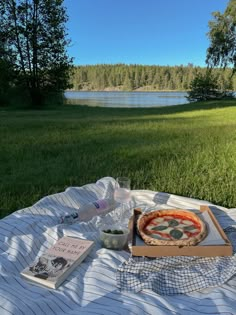 a pizza sitting on top of a blanket next to a book