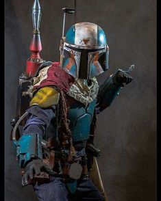 the boba fett costume from star wars is displayed in front of a dark background