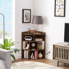 a living room filled with furniture and a flat screen tv on top of a wooden stand