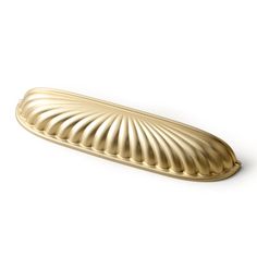 a gold scallop shell shaped object on a white background with clipping for text