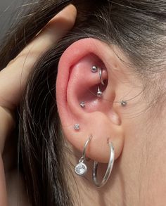 a close up of a person with ear piercings on their left and right sides