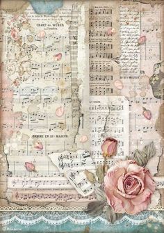 a pink rose sitting on top of a piece of paper with music sheets in the background