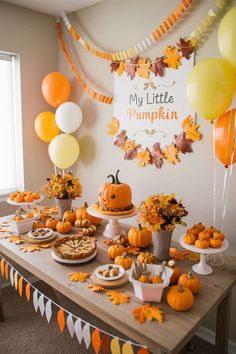 a table topped with lots of desserts and balloons in front of a sign that says my little pumpkin