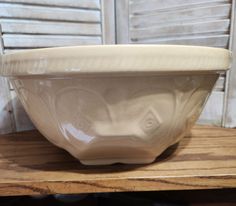 a white bowl sitting on top of a wooden table