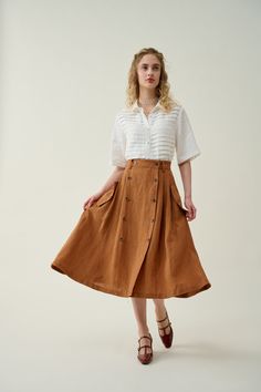 "Brown Button linen Skirt, A-line midi skirt, high waist skirt,  What is comfortable, charismatic-looking and elegantly feminine? You guessed it, it's this button-up skirt from Linennaive. It's cut from lightweight linen in an A-line silhouette. Front buttons design makes its A-line silhouette more dramatic. will adds a touch of timeless elegance to your outfit. The brown hue is endlessly versatile - Easily create a polished yet chic look. This skirt can be dressed up or down with different accessories, making it perfect for any occasion. 【Fabric】 100% Linen, around 170g/gram 【Length】 31 inches. 【Size】 *SIZE XS  waist: 26\"/ 65 cm *SIZE S  waist: 27\"/ 70 cm *SIZE M  waist: 29/ 75 cm *SIZE L waist: 31.5\" / 80 cm SIZE XL Waist: 33\"/ 85cm SIZE XXL  waist : 35\" / 90 cm SIZE 3XL  waist : 37 Linen Skirt Outfit, Brown Skirt Outfit, A Line Skirt Outfits, Safari Outfits, Buttons Design, Button Front Skirt, Button Up Skirts, Skirt High Waist, Button Skirt