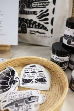 some black and white stickers are on a wicker basket next to other items