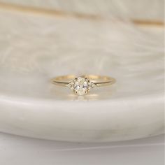 a diamond ring sitting on top of a white plate