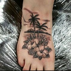 a foot with flowers and palm trees on it