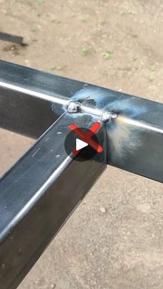 a close up of a metal rail with a red and white piece sticking out of it