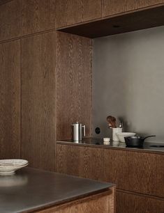 a kitchen with wooden cabinets and stainless steel appliances