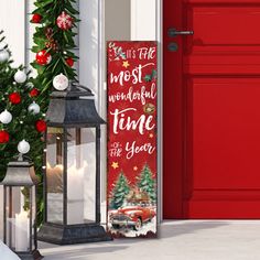 a red door is decorated with christmas decorations and holiday wreaths as well as a sign that reads, it's the most wonderful time for the year