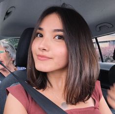 a woman sitting in the back seat of a car