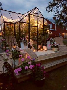 a house that is lit up with candles and flowers on the steps leading to it