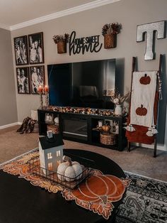 a living room decorated for halloween with decorations on the wall and pictures above the fireplace