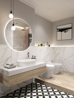 a bathroom with two sinks and a large round mirror above the sink, along with a black and white patterned floor