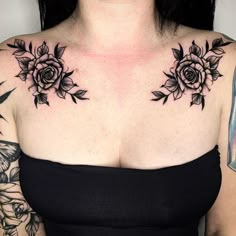 a woman with tattoos on her chest wearing a black dress