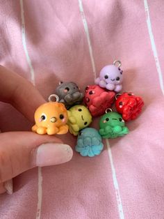 a hand holding a bunch of small plastic animals